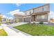 Beautiful two-story home with a covered porch, two car garage and a green yard at 4338 Cattle Cross Trl, Castle Rock, CO 80104