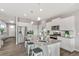 Modern kitchen with white cabinets, stainless steel appliances, and a large island with bar stool seating at 4338 Cattle Cross Trl, Castle Rock, CO 80104