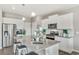 Modern kitchen with white cabinets, stainless steel appliances, and a large island with bar stool seating at 4338 Cattle Cross Trl, Castle Rock, CO 80104