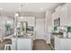 Modern kitchen with white cabinets, stainless steel appliances, and a large island with bar stool seating at 4338 Cattle Cross Trl, Castle Rock, CO 80104