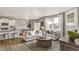 Open concept living room with ample seating, kitchen with bar, and dining area at 4338 Cattle Cross Trl, Castle Rock, CO 80104