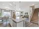 Open concept living space combines kitchen, dining, and living room areas with gray walls and lots of natural light at 4338 Cattle Cross Trl, Castle Rock, CO 80104