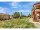 Expansive backyard showcasing a lush lawn, a trampoline, and steps leading to a deck at 22268 E Hidden Trail Dr, Parker, CO 80138