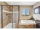 A glass shower sits next to a soaking tub that boasts a great view from its large window at 22268 E Hidden Trail Dr, Parker, CO 80138