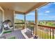 Covered deck with hanging chair, wooden railings, and scenic views at 22268 E Hidden Trail Dr, Parker, CO 80138