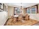 Formal dining room featuring a wooden table with seating for six, elegant chandelier, and decorative rug at 22268 E Hidden Trail Dr, Parker, CO 80138
