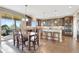 Open kitchen features stainless steel appliances, granite counters, hardwood floors, and eat-in island at 22268 E Hidden Trail Dr, Parker, CO 80138