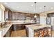 Gourmet kitchen featuring dark wood cabinetry, granite countertops, stainless appliances and eat-in island at 22268 E Hidden Trail Dr, Parker, CO 80138