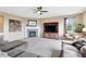 Cozy living room with a stone fireplace, plush carpeting, and ample natural light at 22268 E Hidden Trail Dr, Parker, CO 80138