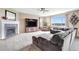 Bright living room featuring a fireplace, neutral tones, large windows, and comfortable seating at 22268 E Hidden Trail Dr, Parker, CO 80138