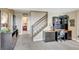 Spacious living room with desk and stairs to upper level for work and easy movement throughout the home at 22268 E Hidden Trail Dr, Parker, CO 80138