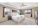 Relaxing main bedroom with large windows, comfortable bedding, and side tables with lamps at 22268 E Hidden Trail Dr, Parker, CO 80138