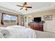 Spacious main bedroom with a ceiling fan, ensuite bathroom entrance, and large dresser at 22268 E Hidden Trail Dr, Parker, CO 80138