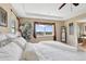 Main bedroom featuring a tray ceiling, large window with natural light, and plush bedding at 22268 E Hidden Trail Dr, Parker, CO 80138