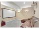 Cozy theater room featuring a large screen, projector, gray carpet, and comfortable brown leather seating at 22268 E Hidden Trail Dr, Parker, CO 80138