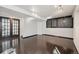 Finished basement with hardwood flooring, track lighting, and dark wood doors; stylish living area at 4965 Collinsville Pl, Highlands Ranch, CO 80130