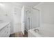 Bathroom showcasing a glass-enclosed shower, soaking tub, and modern fixtures in a brightly lit space at 4965 Collinsville Pl, Highlands Ranch, CO 80130