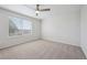 Spacious bedroom featuring neutral carpet and a ceiling fan for comfortable living at 4965 Collinsville Pl, Highlands Ranch, CO 80130