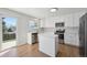 Bright kitchen featuring white cabinetry, stainless steel appliances, and a stylish island at 4965 Collinsville Pl, Highlands Ranch, CO 80130