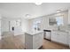 Well-lit kitchen with island, stainless steel dishwasher, and bright, open layout at 4965 Collinsville Pl, Highlands Ranch, CO 80130