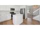 Modern kitchen with white cabinetry, stainless steel appliances, and a convenient island at 4965 Collinsville Pl, Highlands Ranch, CO 80130