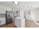Beautiful kitchen featuring white cabinets, island, and stainless steel refrigerator at 4965 Collinsville Pl, Highlands Ranch, CO 80130