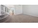 Inviting living area with neutral carpet, staircase, and view to kitchen at 4965 Collinsville Pl, Highlands Ranch, CO 80130