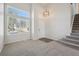 Bright living room featuring a large window, staircase, and modern lighting at 4965 Collinsville Pl, Highlands Ranch, CO 80130