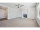 Inviting living room with neutral carpet, ceiling fan, and fireplace at 4965 Collinsville Pl, Highlands Ranch, CO 80130