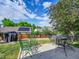 Paver patio with outdoor seating and a grill, perfect for enjoying sunny days in the backyard at 5319 E Davies Dr, Centennial, CO 80122