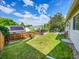 Spacious backyard with a well-maintained lawn, wooden fence, and patio area for outdoor activities at 5319 E Davies Dr, Centennial, CO 80122