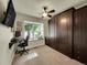 This bedroom features a built-in murphy bed, a ceiling fan, carpet, and a window seat at 5319 E Davies Dr, Centennial, CO 80122