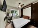 Bedroom showcasing a murphy bed extended, a ceiling fan, carpet, and a window seat at 5319 E Davies Dr, Centennial, CO 80122