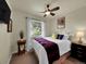Cozy bedroom featuring a ceiling fan, closet, and a large window at 5319 E Davies Dr, Centennial, CO 80122
