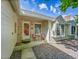 Inviting front entrance with chairs, a decorative storm door and brick accents at 5319 E Davies Dr, Centennial, CO 80122
