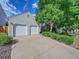 View of home showing a two-car garage, beautiful yard, and charming exterior at 5319 E Davies Dr, Centennial, CO 80122