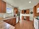Well-lit kitchen featuring custom cabinets, granite countertops, and hardwood floors at 5319 E Davies Dr, Centennial, CO 80122