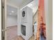 Laundry area featuring a stacked washer and dryer and wash sink at 5319 E Davies Dr, Centennial, CO 80122