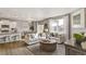 Open living room and kitchen with light-colored sofas and wood floors at 27621 E Cedar Ave, Aurora, CO 80018