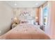 Bright bedroom featuring stylish wallpaper, modern lighting, and a cozy pink bedspread at 3297 N Duquesne Way, Aurora, CO 80019