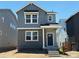 Charming two-story home with gray siding, brick accents, and a covered front porch at 3297 N Duquesne Way, Aurora, CO 80019