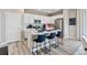Modern kitchen boasts white cabinets, stainless steel appliances and a center island with seating at 3297 N Duquesne Way, Aurora, CO 80019