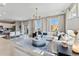 Bright living room with ample seating, modern lighting, and large windows at 3297 N Duquesne Way, Aurora, CO 80019