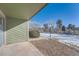 Private patio with gravel and snowy landscape view at 14110 E Temple Dr # X02, Aurora, CO 80015