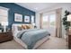 Serene primary bedroom featuring a blue accent wall, neutral carpet, and large windows with scenic views at 138 S Seacrest St, Golden, CO 80401