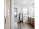 Bright bathroom featuring a glass enclosed shower, a window, wood look floors, and a vanity at 16019 E Elk Dr, Denver, CO 80239