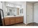 Double vanity bathroom with ample counter space, large mirror, and sleek lighting fixtures at 16019 E Elk Dr, Denver, CO 80239