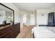 A bedroom featuring plush carpet, a dresser with mirror, an ensuite bathroom, and plenty of space at 16019 E Elk Dr, Denver, CO 80239
