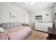 Cozy bedroom featuring a gray upholstered daybed and a white dresser with a mounted TV at 16019 E Elk Dr, Denver, CO 80239