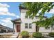 Charming home exterior featuring a modern design, red front door, and lush green bushes at 16019 E Elk Dr, Denver, CO 80239